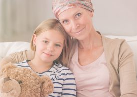 Ill,Woman,With,Headscarf,Embracing,Her,Small,Child